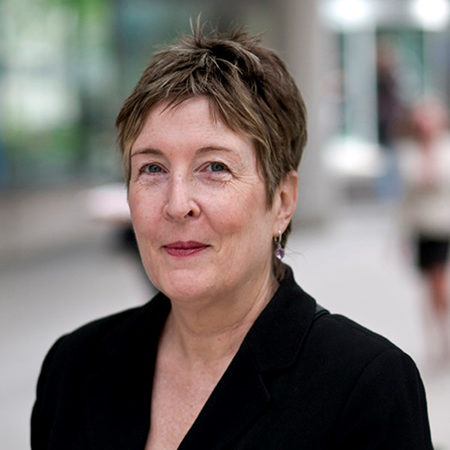 Janice Du Mont, seen from the shoulders up, wearing a black blazer and short brown hair